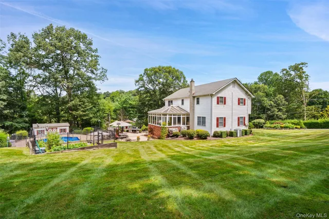 a backyard of a house with table and chairs