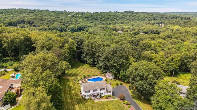 an aerial view of a house with a yard
