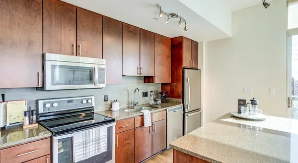 a kitchen with sink cabinets and stainless steel appliances