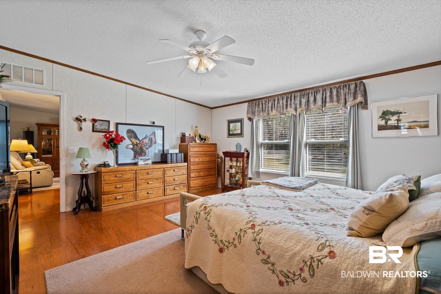 10647 Rte Road Lillian, AL 36549 - Photo 43 of 62 Bedroom featuring a textured ceiling, visible vents, crown molding, and wood finished floors