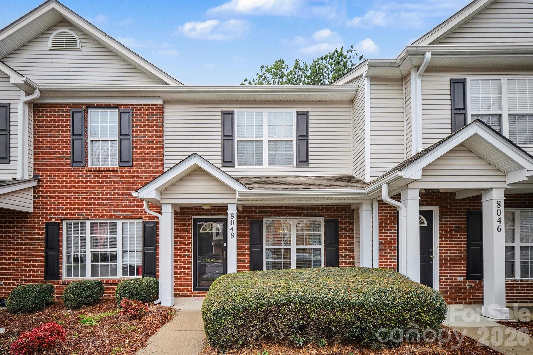 8048 Stoneham Court Matthews, NC 28105 - Photo 1 of 15 front view of a brick house with a window