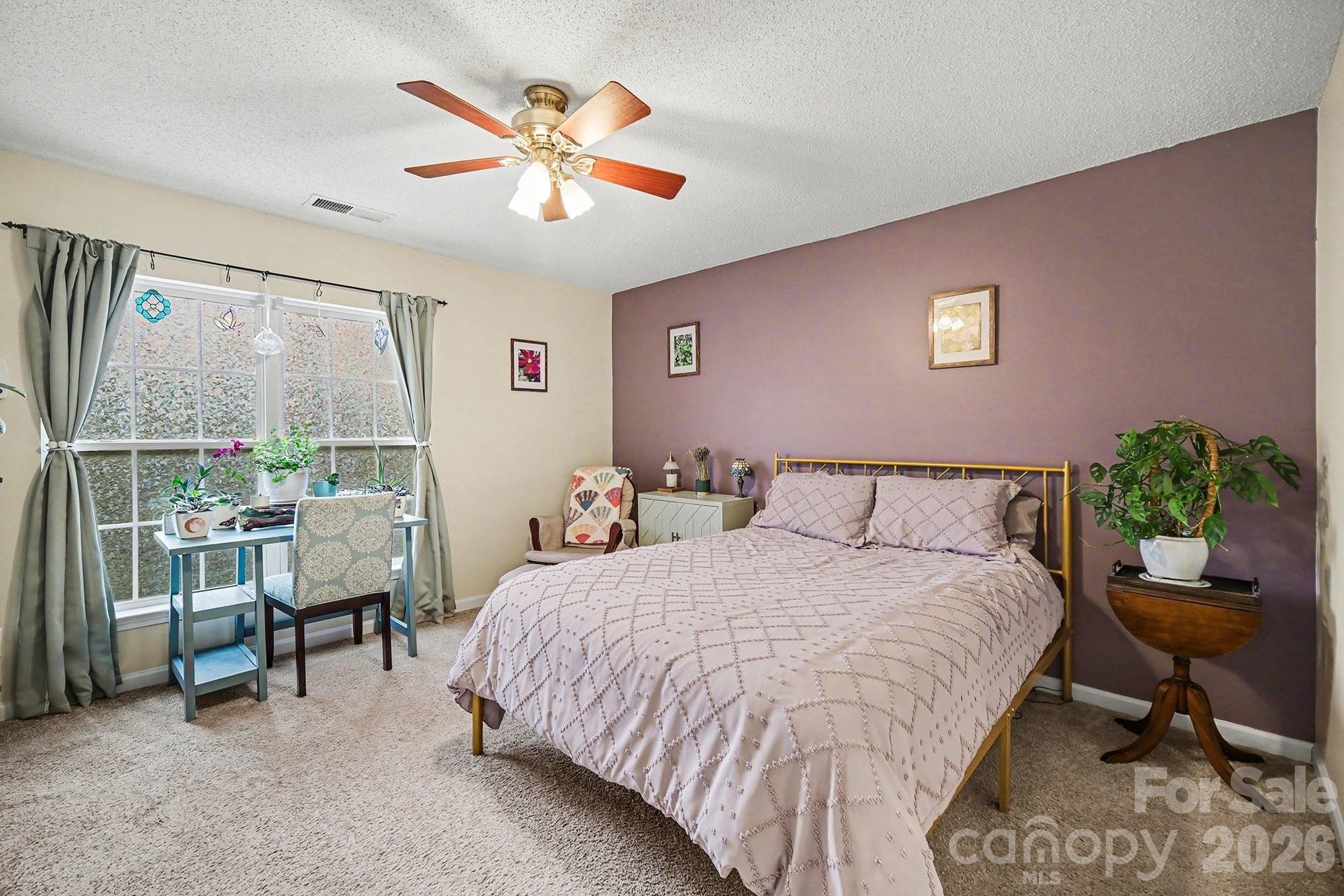 8048 Stoneham Court Matthews, NC 28105 - Photo 11 of 15 a bedroom with a bed and a large window