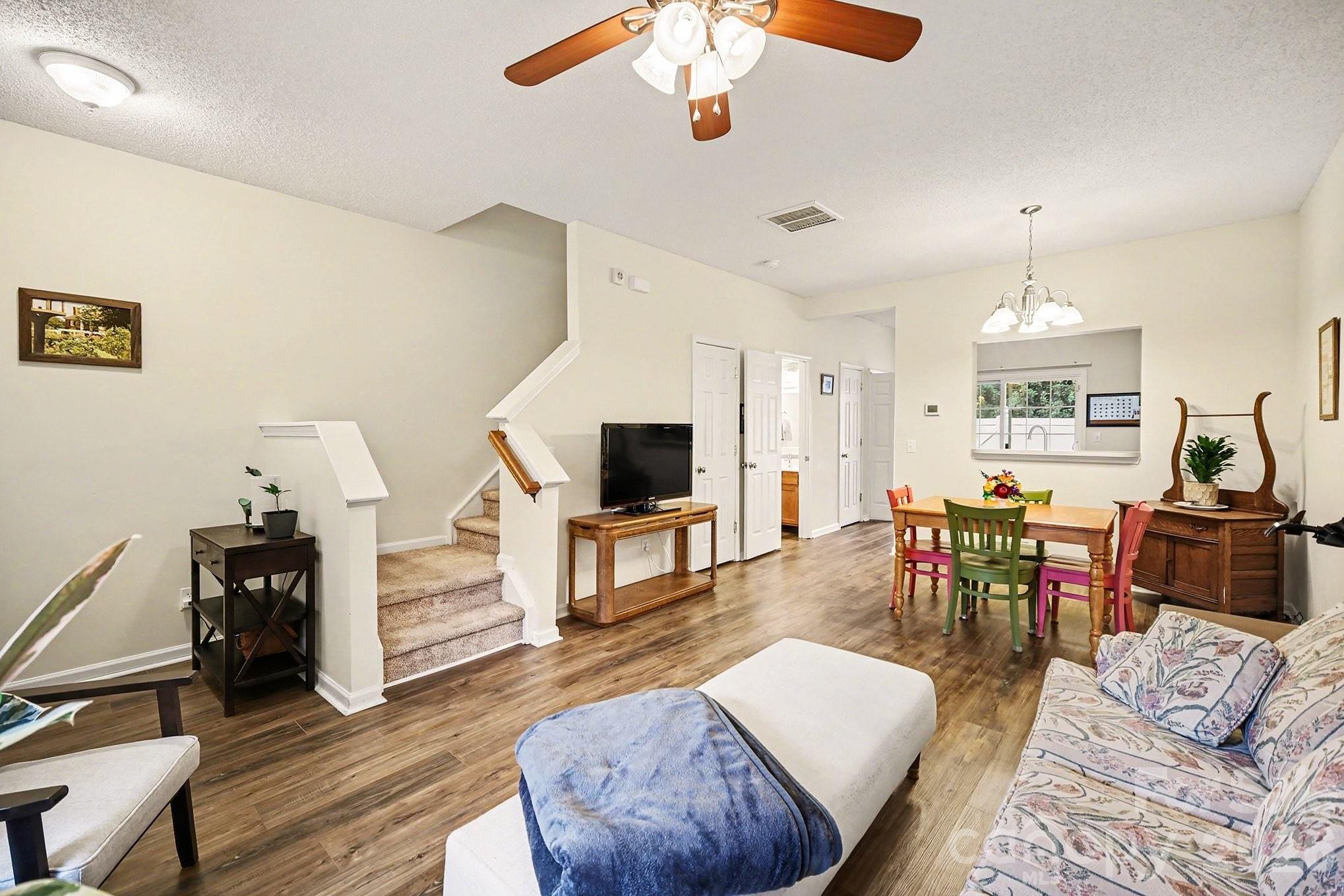 8048 Stoneham Court Matthews, NC 28105 - Photo 3 of 15 a living room with furniture or couch and a flat screen tv