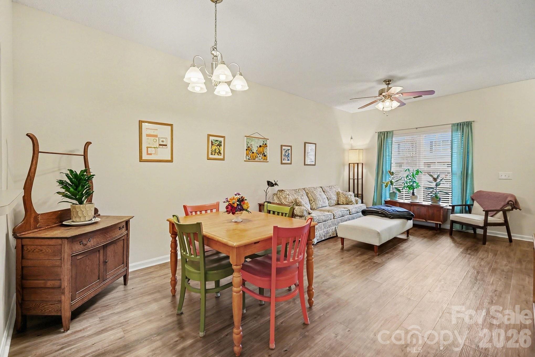 8048 Stoneham Court Matthews, NC 28105 - Photo 4 of 15 a view of a dining room with furniture window and wooden floor