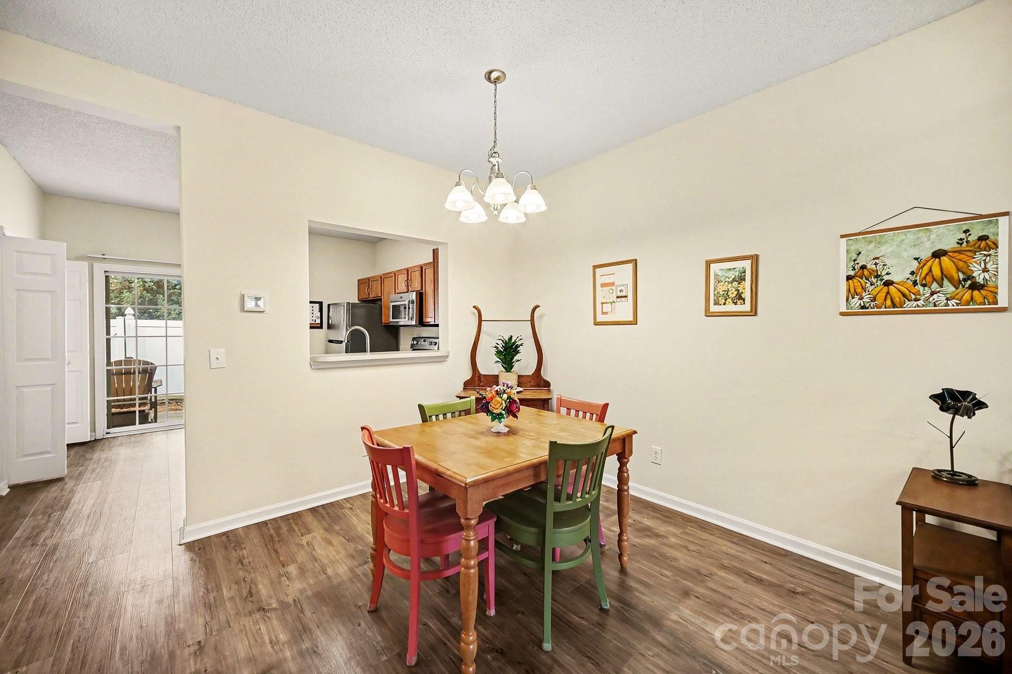 8048 Stoneham Court Matthews, NC 28105 - Photo 5 of 15 a dining room with wooden floor and breakfast area