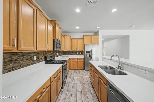a kitchen with a sink stove top oven and cabinets