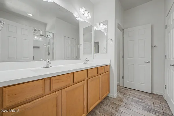 a bathroom with double vanity sinks and a mirror