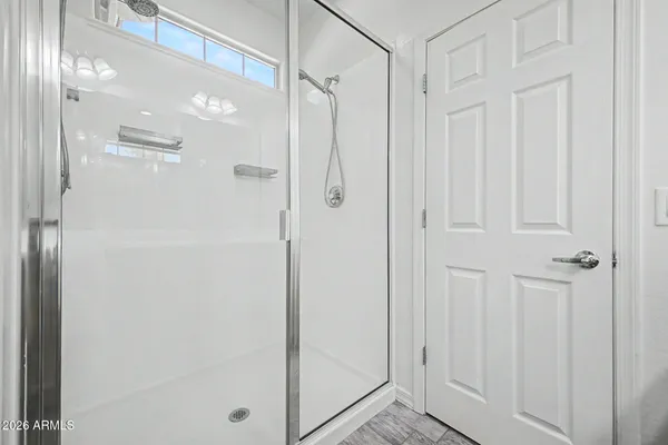 a bathroom with a glass shower door