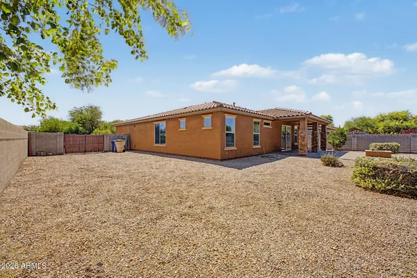 a row of palm trees and a fire pit with large trees