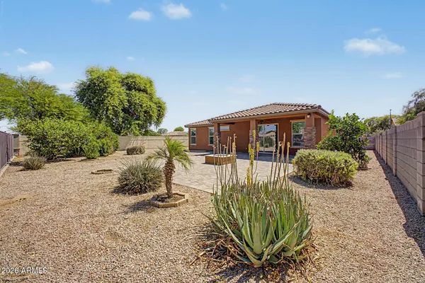a view of a house with backyard and sitting area