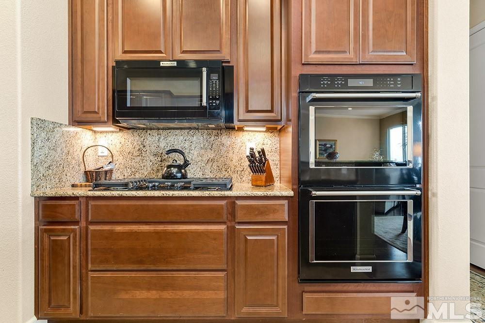 9266 Maplehurst Trail Reno, NV 89523 - Photo 15 of 29 a kitchen with granite countertop white cabinets and stainless steel appliances