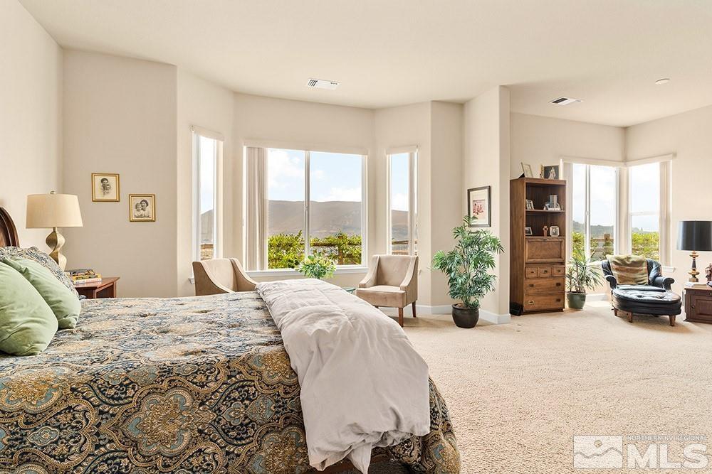 9266 Maplehurst Trail Reno, NV 89523 - Photo 16 of 29 a bedroom with a bed and large windows