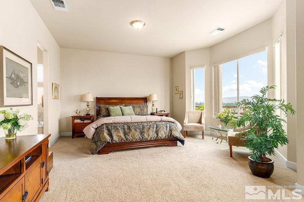 9266 Maplehurst Trail Reno, NV 89523 - Photo 17 of 29 a bedroom with a large bed and a potted plant