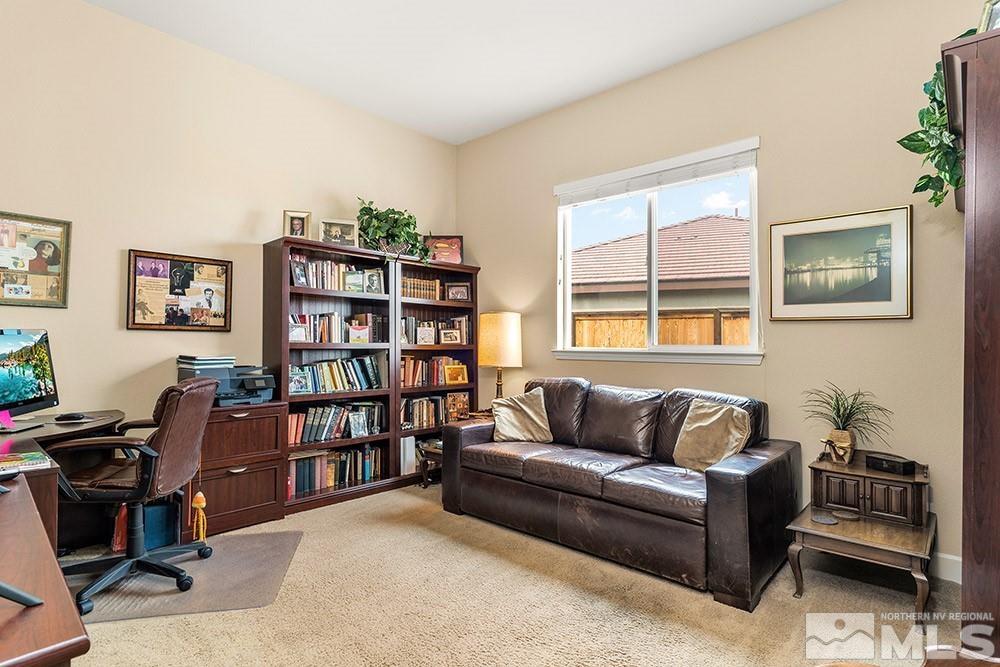 9266 Maplehurst Trail Reno, NV 89523 - Photo 20 of 29 a living room with couch a bookshelf and a window