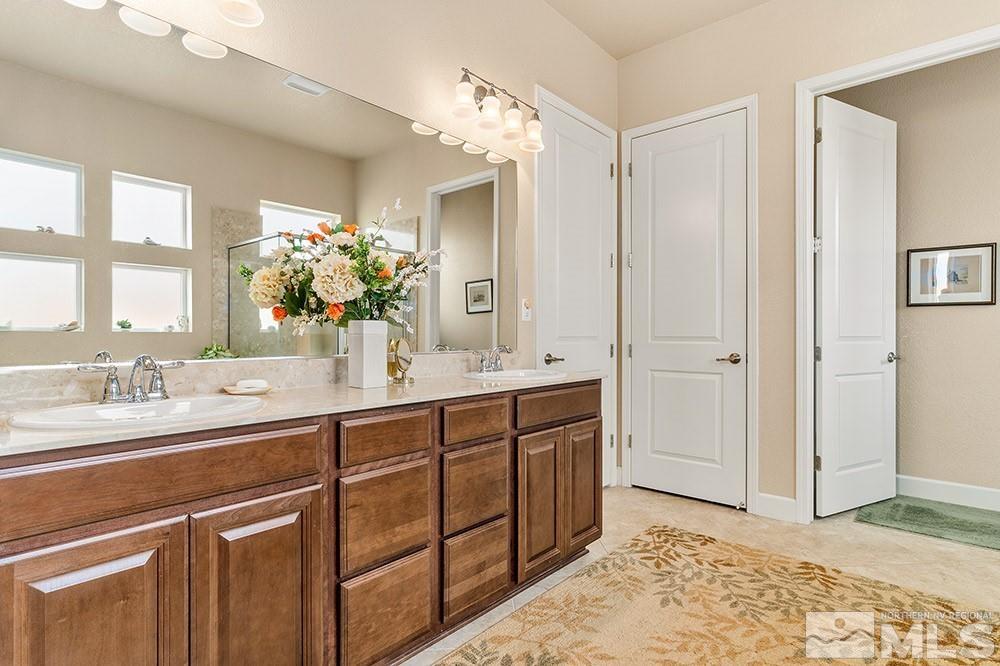 9266 Maplehurst Trail Reno, NV 89523 - Photo 24 of 29 a spacious bathroom with a granite countertop sink a mirror and a