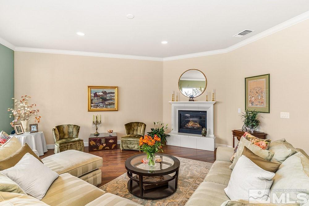 9266 Maplehurst Trail Reno, NV 89523 - Photo 5 of 29 a living room with furniture a fireplace and a mirror