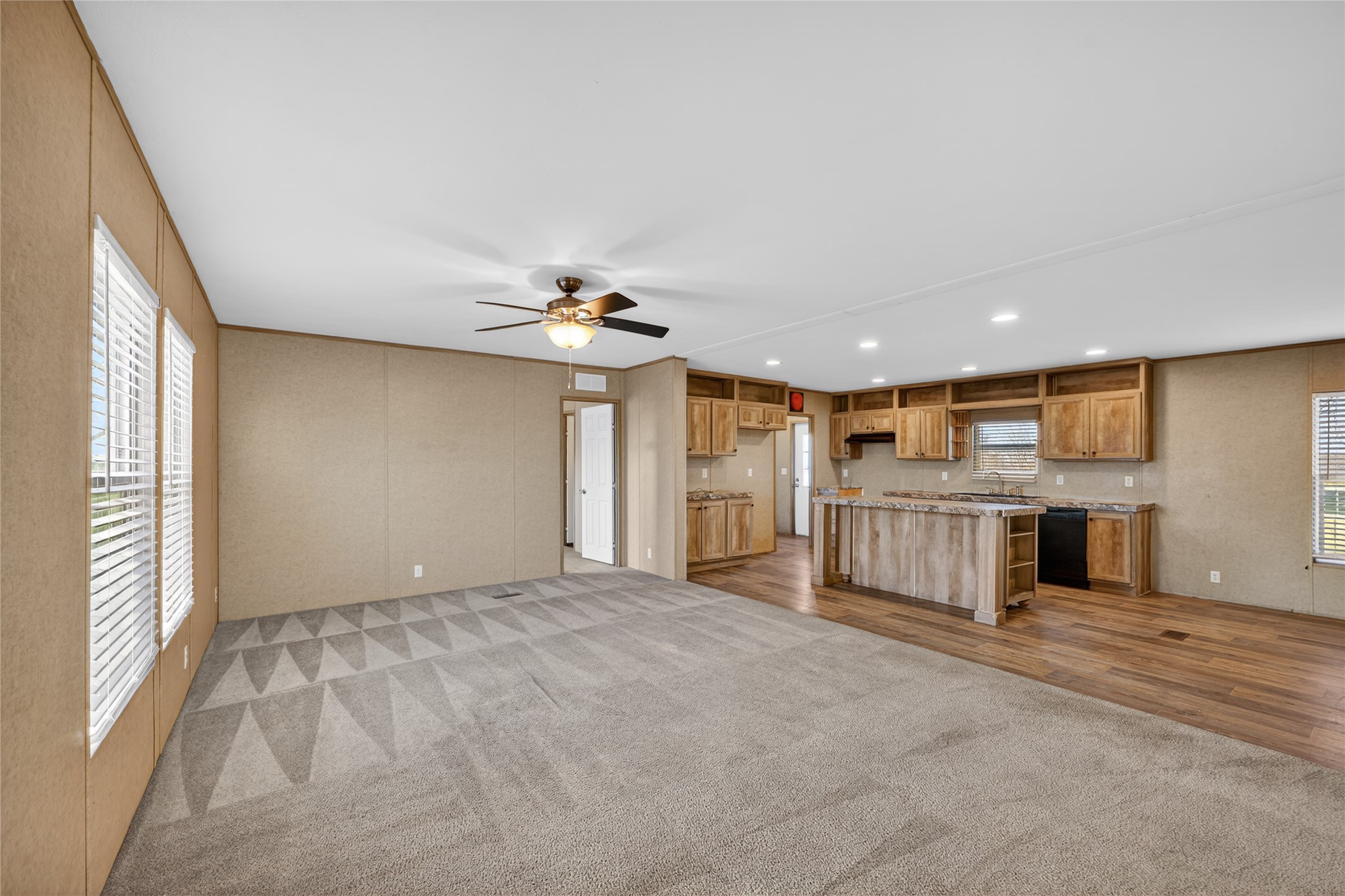 2674 Cotton Gin Road Kyle, TX 78640 - Photo 18 of 30 Unfurnished living room with ceiling fan, dark carpet, and recessed lighting