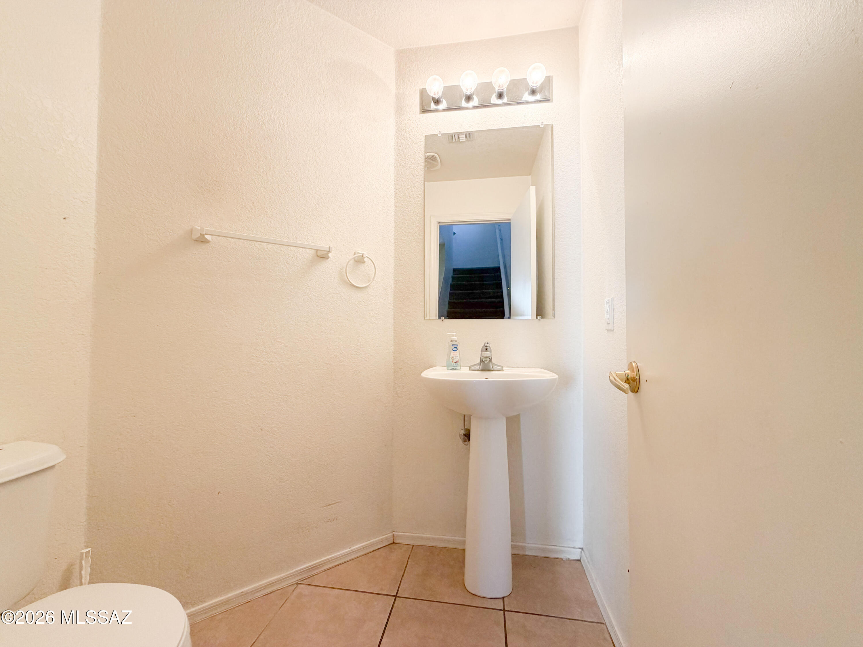 5779 South Manta Ray Road Tucson, AZ 85706 - Photo 10 of 30 a bathroom with a sink toilet and mirror
