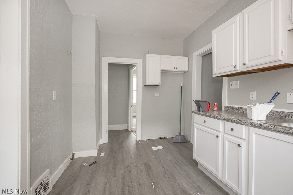 1000 Eddy Road Cleveland, OH 44108 - Photo 29 of 38 Kitchen with white cabinets and light wood finished floors