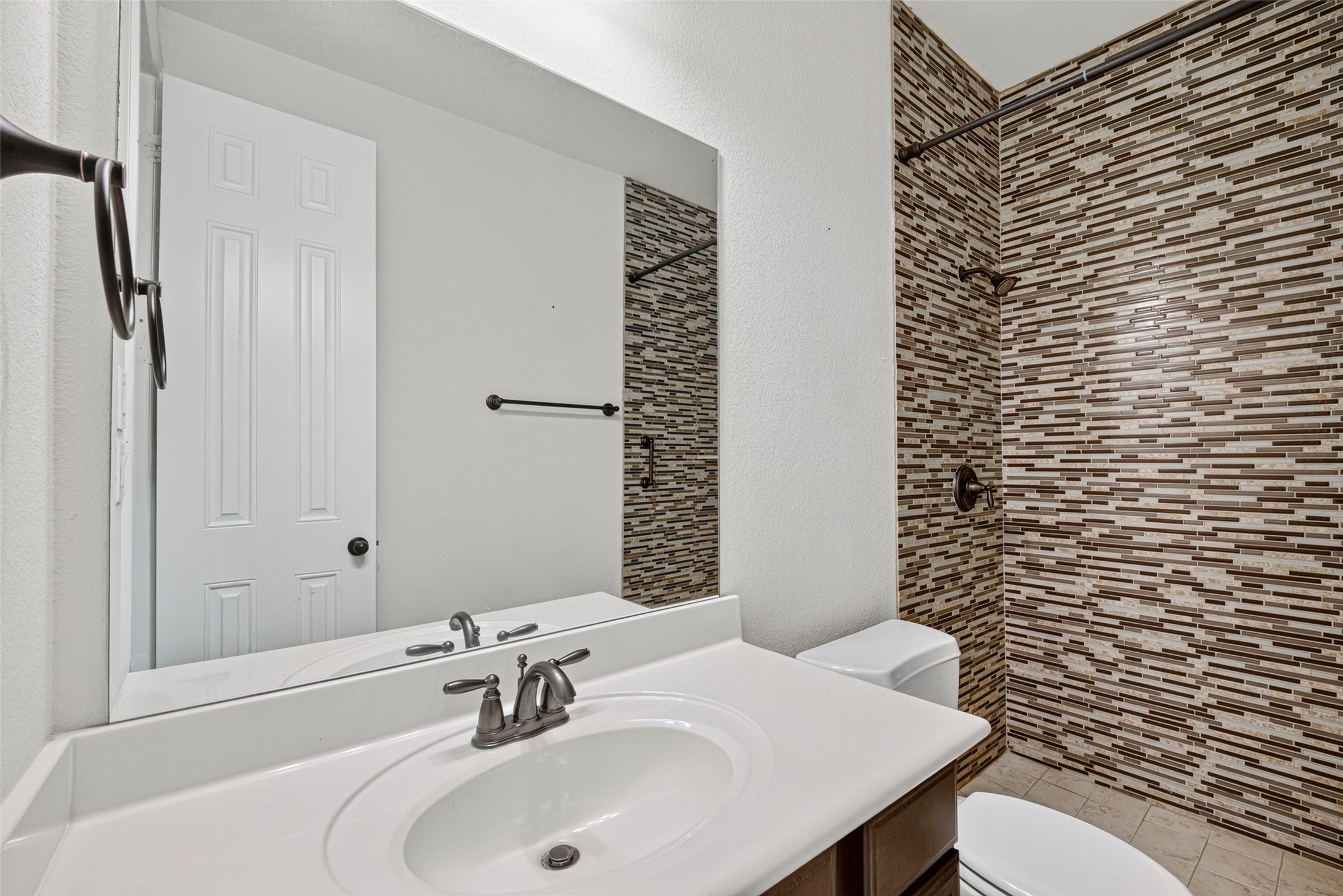 7930 Summer Night Lane Rosenberg, TX 77469 - Photo 27 of 48 Well-appointed secondary bathroom featuring a spacious vanity and a standing shower.