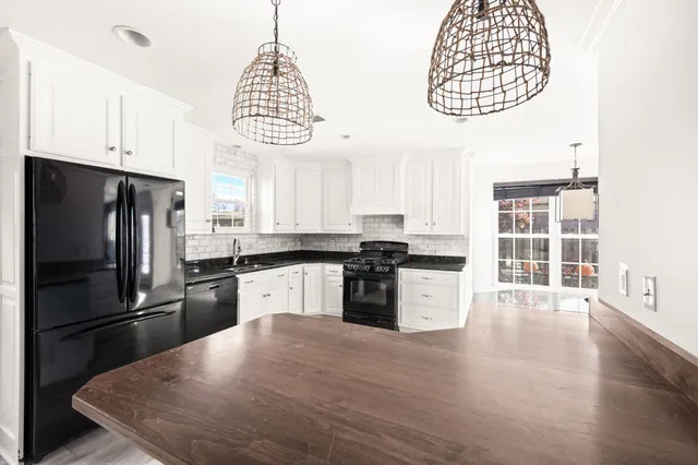 a kitchen with a refrigerator a sink dishwasher a stove and a microwave