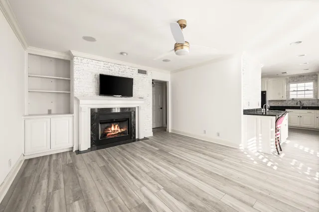 a view of an empty room with fire place and a fireplace