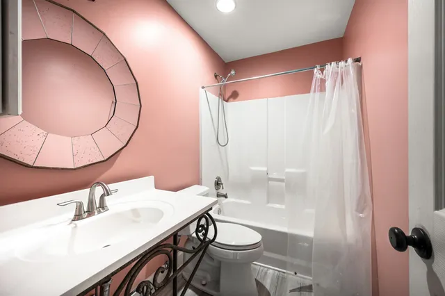 a bathroom with a sink and mirror