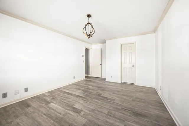 a view of a room with wooden floor and windows
