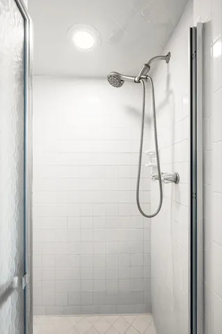 a bathroom that has a glass shower door