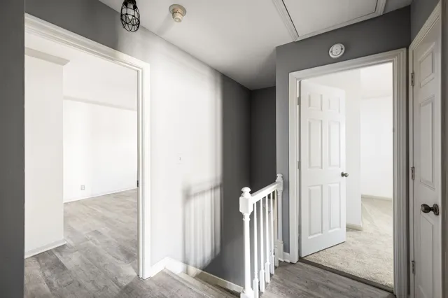 a view of a hallway with wooden floor and entryway