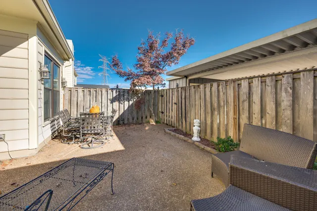 a view of a porch with a wooden fence