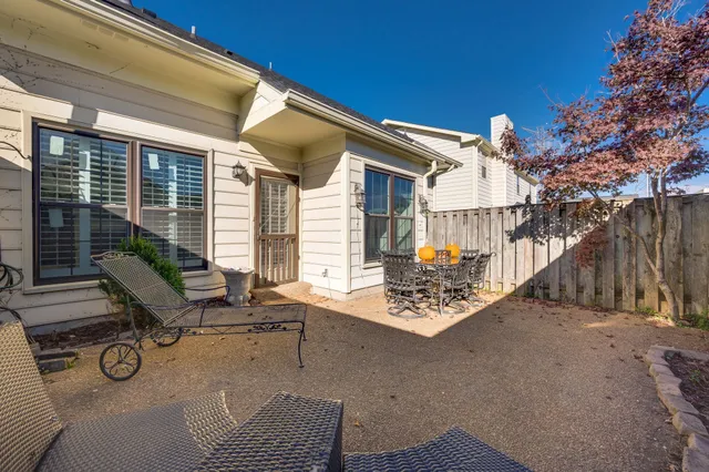 a view of a chairs and tables in the back yard of the house