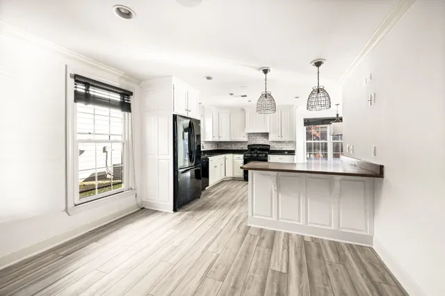 a kitchen with stainless steel appliances a refrigerator sink and cabinets
