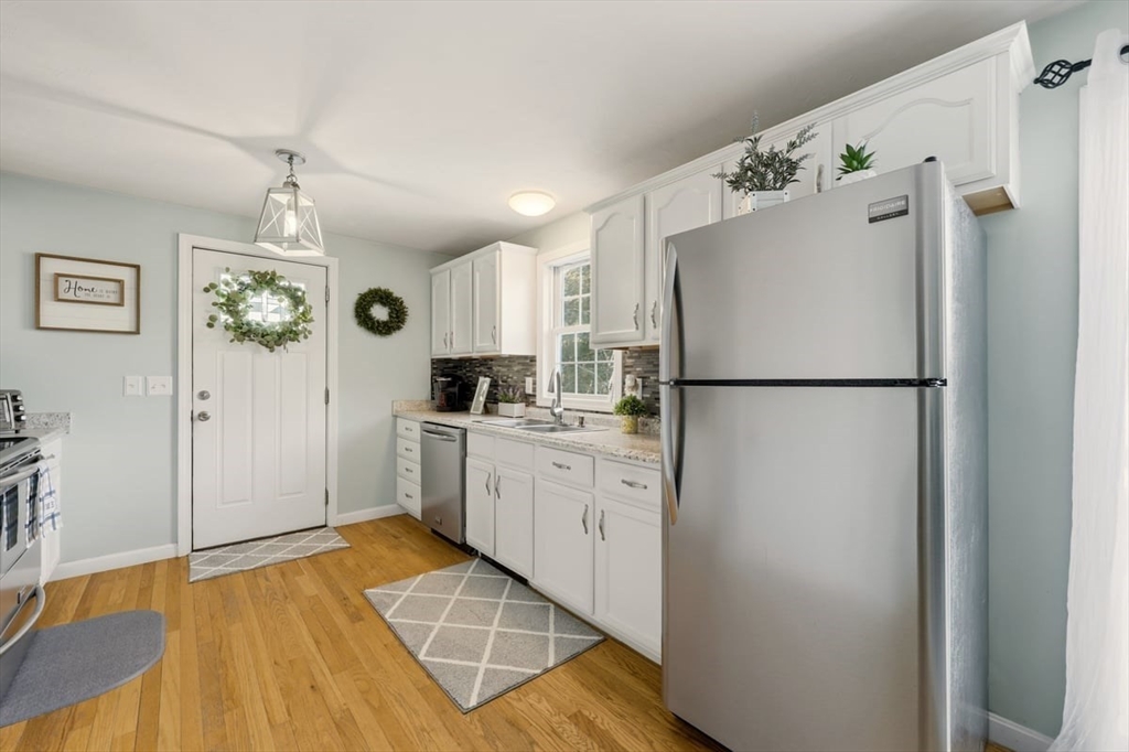 19 Station Street Wareham, MA 02571 - Photo 18 of 41 a kitchen with a refrigerator a stove top oven a sink and dishwasher