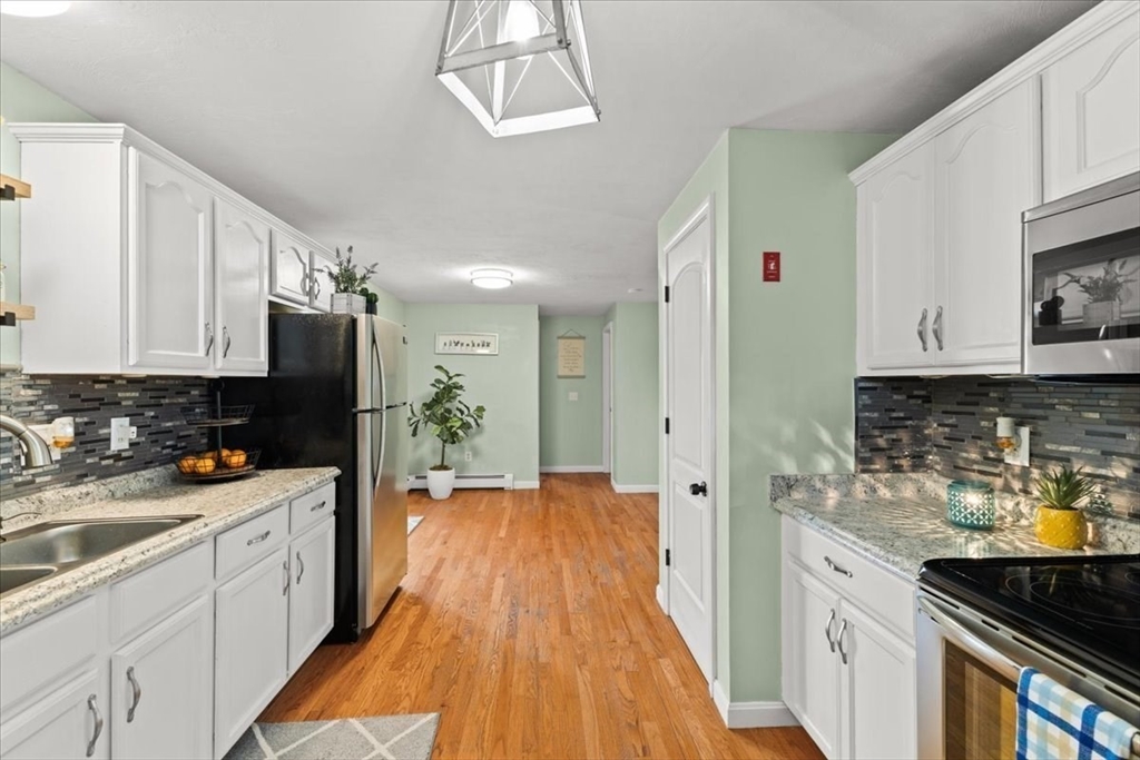 19 Station Street Wareham, MA 02571 - Photo 19 of 41 a kitchen with a sink a stove and cabinets