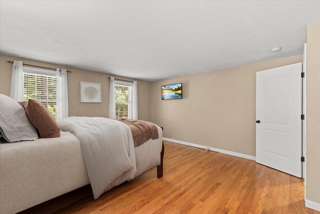 19 Station Street Wareham, MA 02571 - Photo 28 of 41 a bedroom with a large bed and wooden floor
