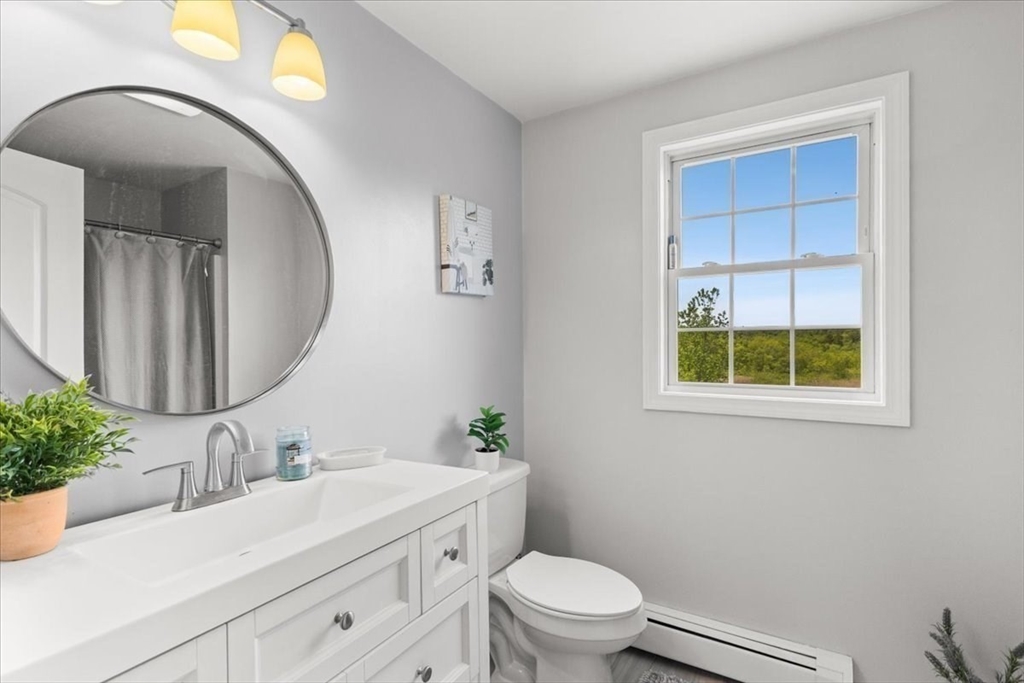19 Station Street Wareham, MA 02571 - Photo 35 of 41 a bathroom with a sink a toilet and a mirror