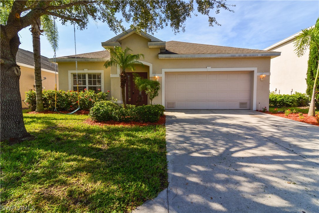 8960 Falcon Pointe Loop Fort Myers, FL 33912 - Photo 1 of 25 a front view of a house with a yard and potted plants