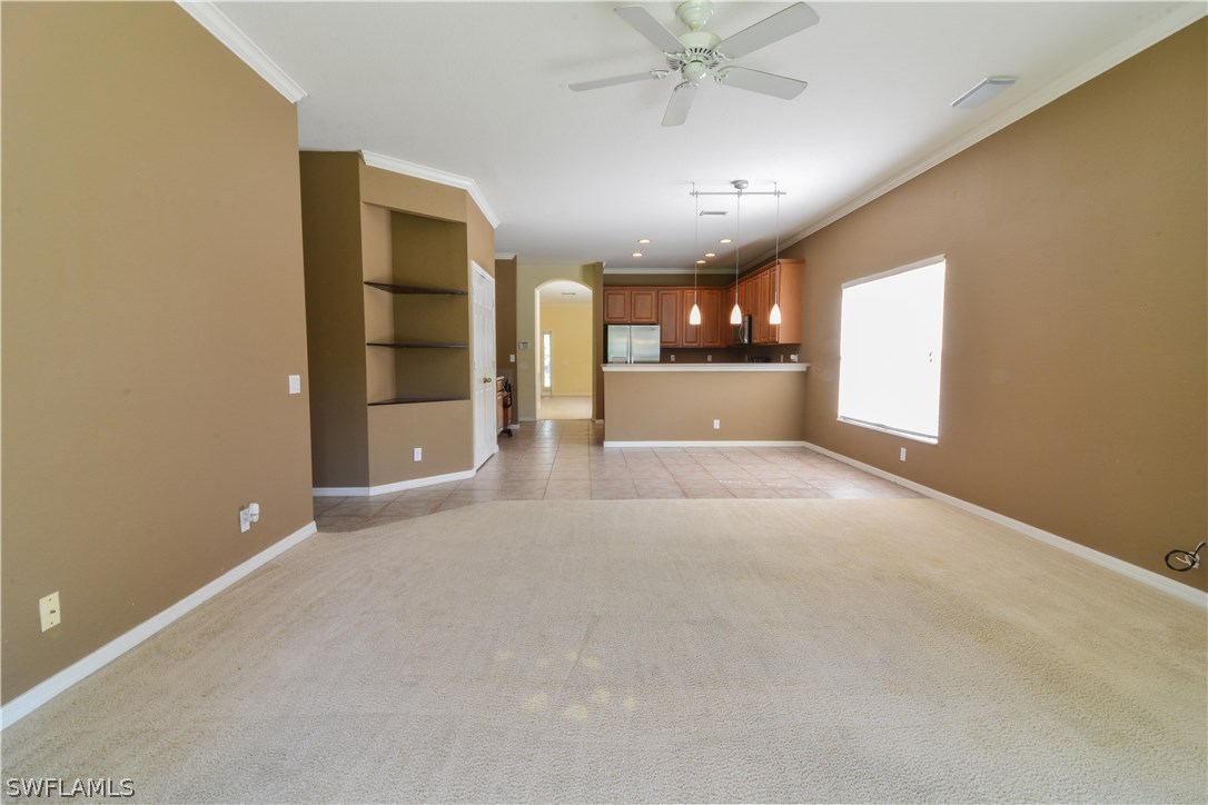 8960 Falcon Pointe Loop Fort Myers, FL 33912 - Photo 11 of 25 an empty room with chandelier fan and windows