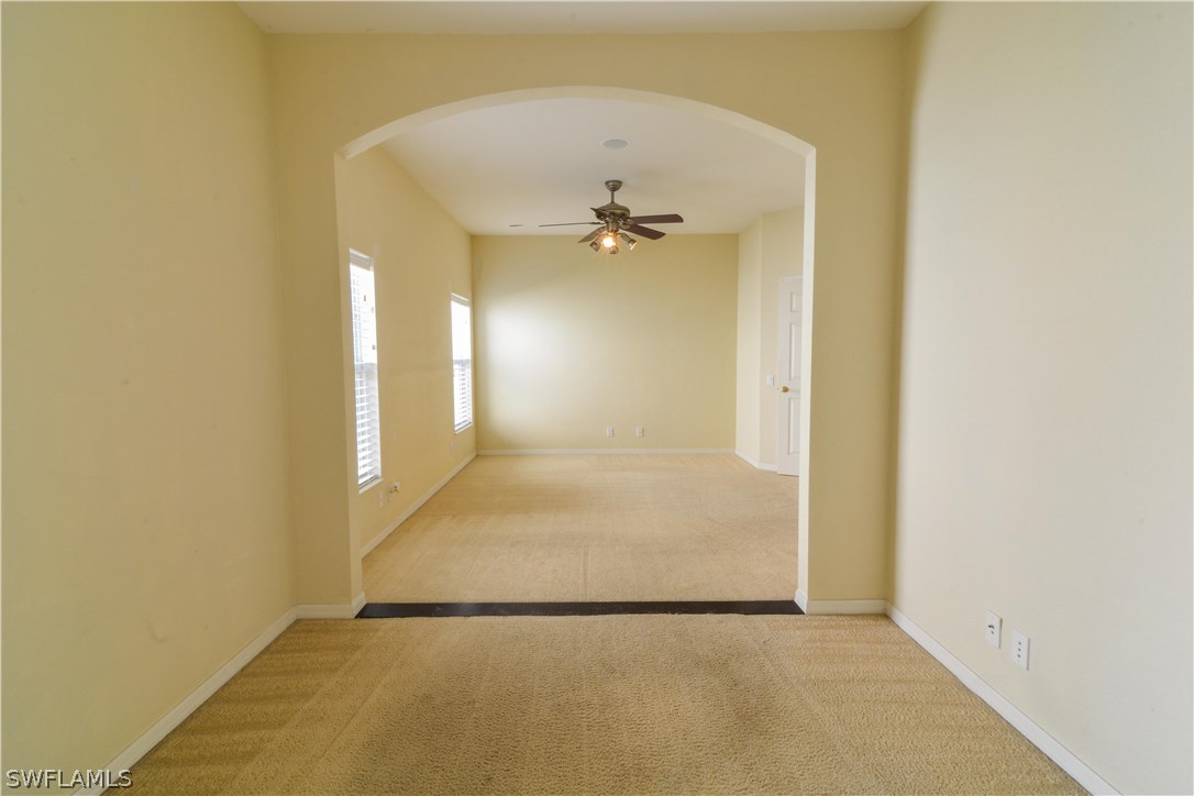 8960 Falcon Pointe Loop Fort Myers, FL 33912 - Photo 13 of 25 an empty room with a windows and ceiling fan