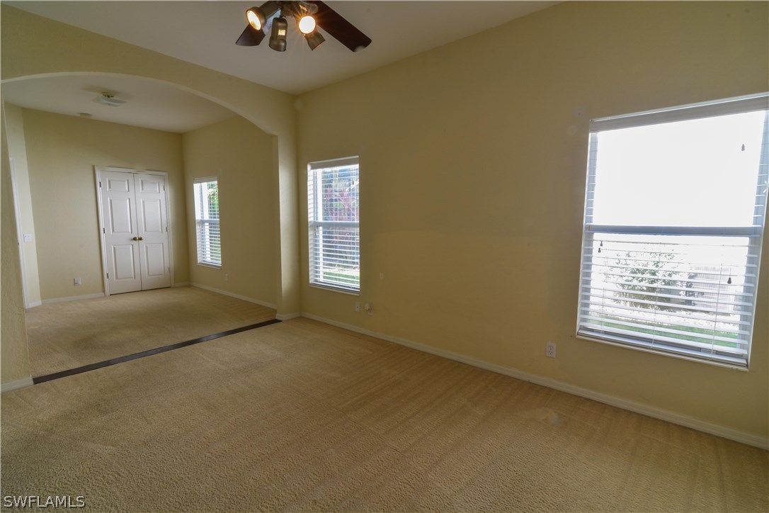 8960 Falcon Pointe Loop Fort Myers, FL 33912 - Photo 15 of 25 a view of an empty room with chandelier fan and window