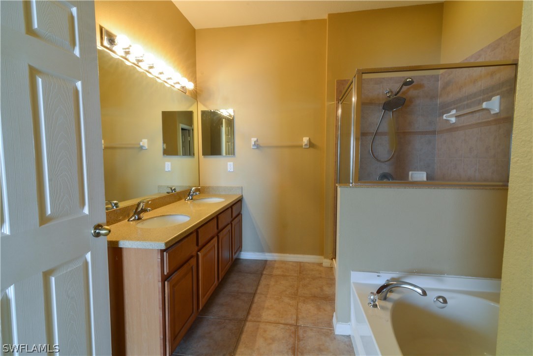 8960 Falcon Pointe Loop Fort Myers, FL 33912 - Photo 16 of 25 a bathroom with a sink and mirror