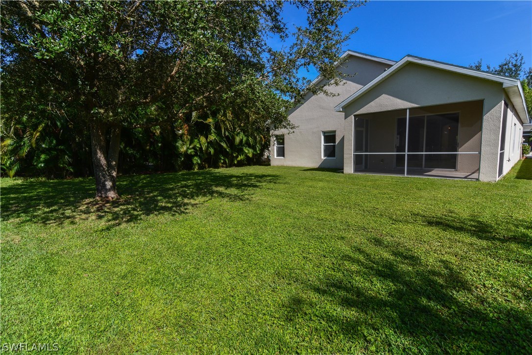 8960 Falcon Pointe Loop Fort Myers, FL 33912 - Photo 2 of 25 a house with green field in front of it