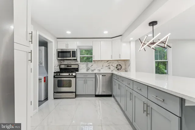 a kitchen with a sink stainless steel appliances and cabinets