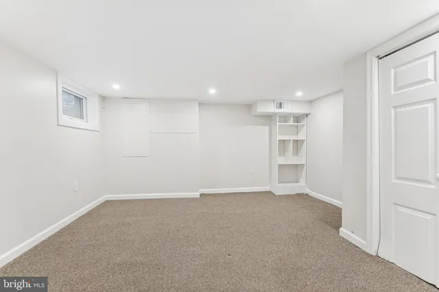 a view of an empty room with a kitchen