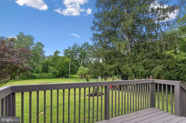 a view of balcony with wooden floor and fence