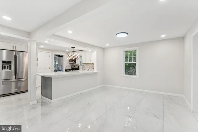 a view of kitchen with refrigerator and window