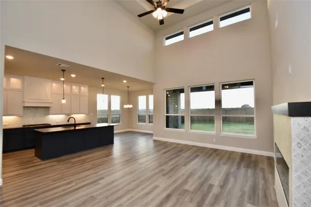 a view of a kitchen with a sink and wooden floor