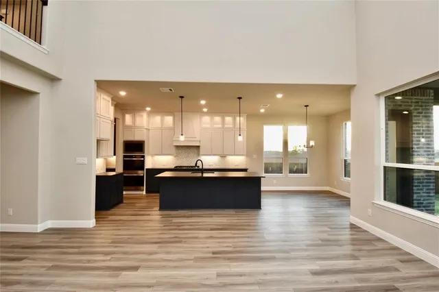 a view of a living room kitchen and a wooden floor