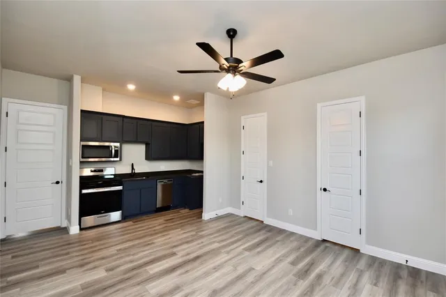 a large kitchen with stainless steel appliances granite countertop a stove and a refrigerator